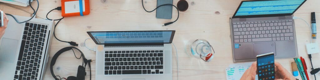 Table with Phones, Computers, and Portable Chargers