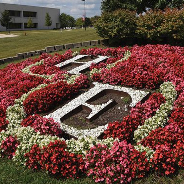 White, Red, and Pink Flower Bed with "H" and "E" Wrote out in Stones